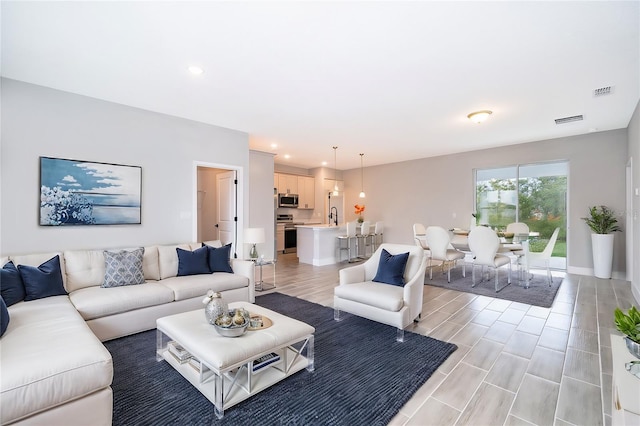 living room with visible vents and recessed lighting