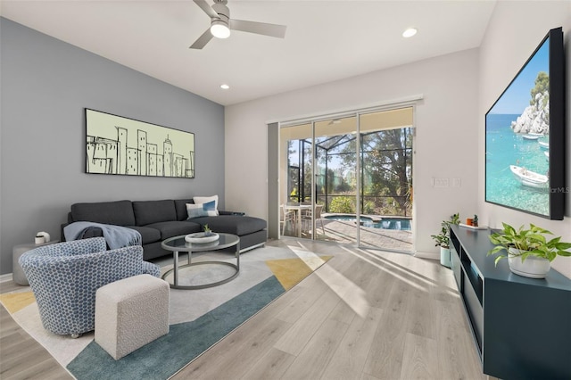 living room with light wood-type flooring and ceiling fan