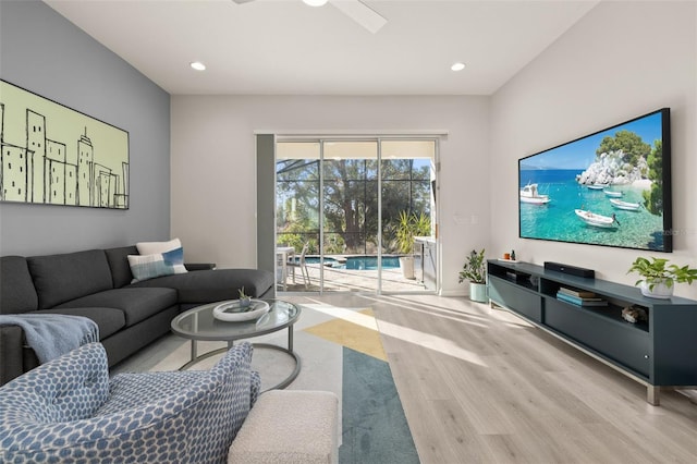 living room featuring ceiling fan and light hardwood / wood-style floors