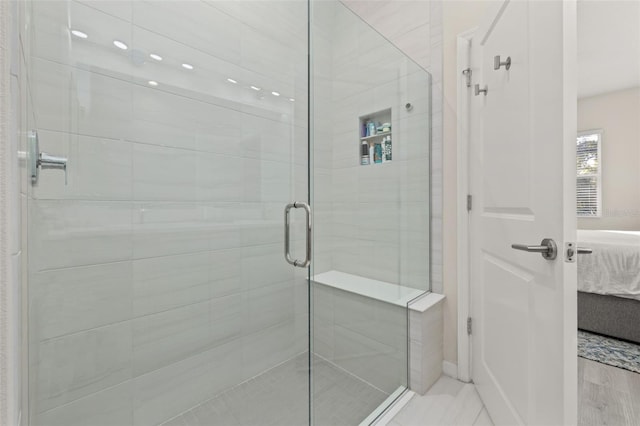 bathroom with a shower with shower door