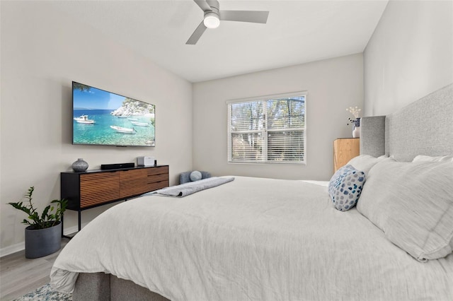 bedroom with ceiling fan and hardwood / wood-style flooring