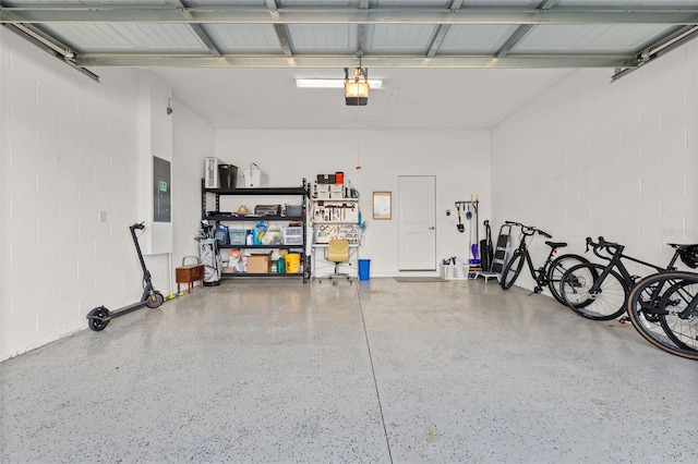 garage with a garage door opener and electric panel