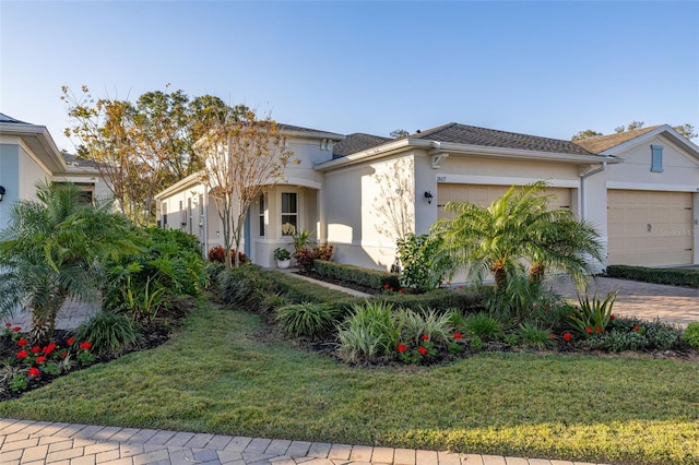 view of front of property with a garage and a front lawn