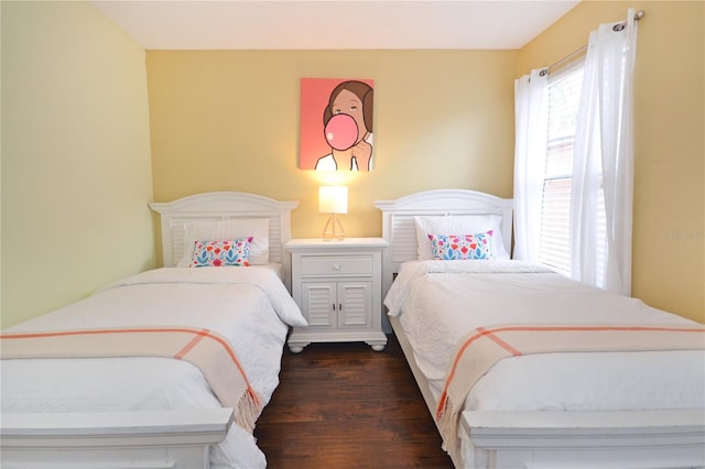 bedroom with dark wood-type flooring