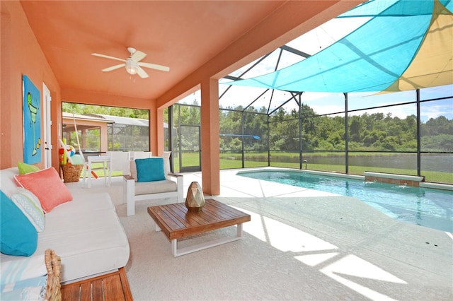 view of swimming pool with ceiling fan, an outdoor hangout area, a patio, and glass enclosure