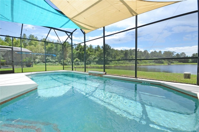 view of pool with a water view and a yard