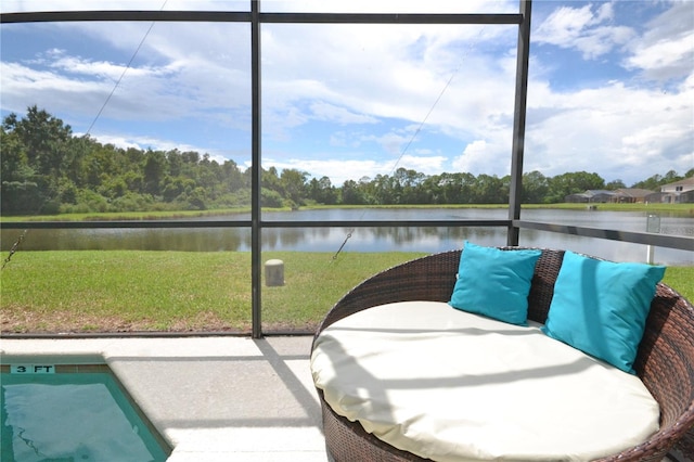 sunroom / solarium featuring a water view