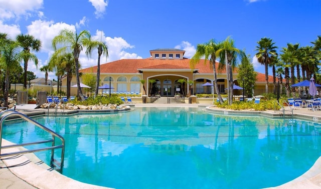 view of swimming pool with french doors