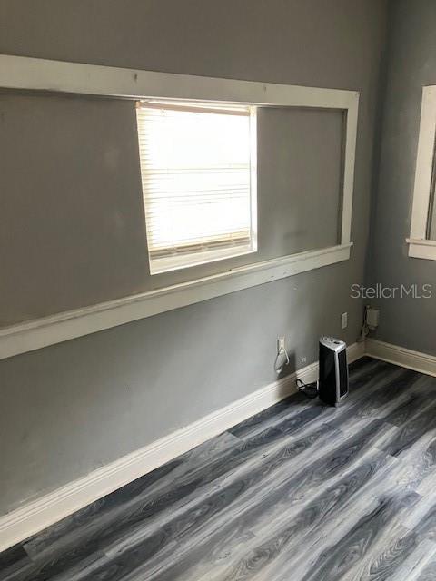 spare room featuring dark hardwood / wood-style flooring