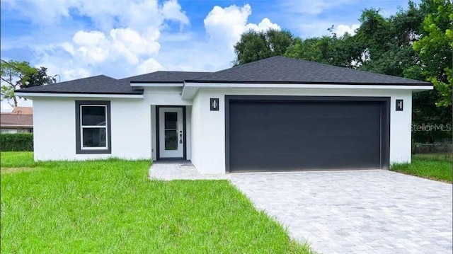 view of front facade with a front yard and a garage