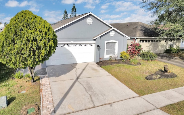 single story home featuring a front yard and a garage