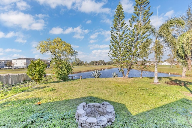 view of yard with a water view and an outdoor fire pit