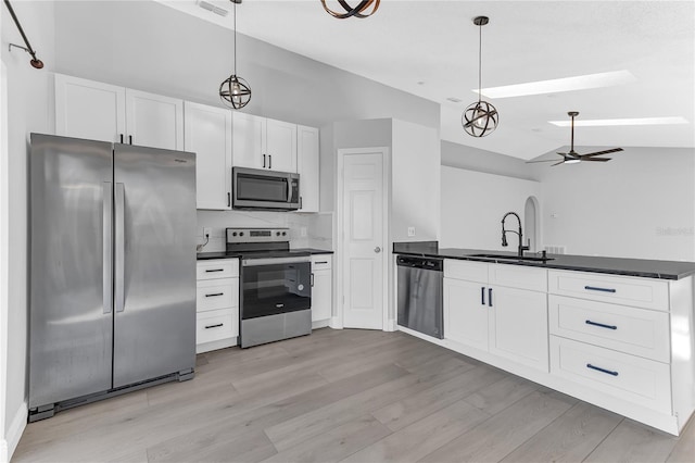 kitchen with ceiling fan, white cabinets, hanging light fixtures, and appliances with stainless steel finishes