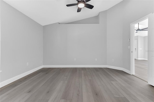 spare room featuring light wood-type flooring, ceiling fan, and lofted ceiling