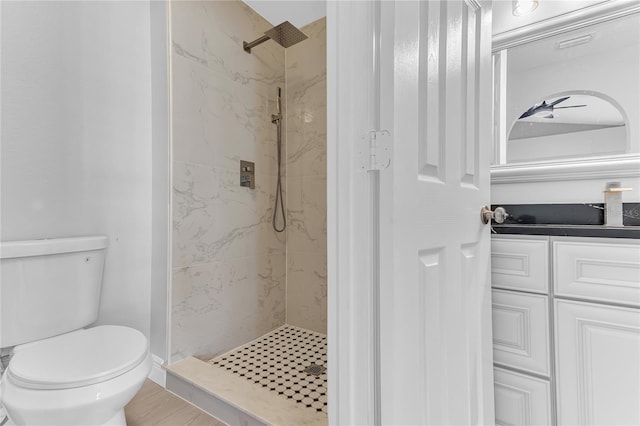 bathroom featuring toilet and tiled shower