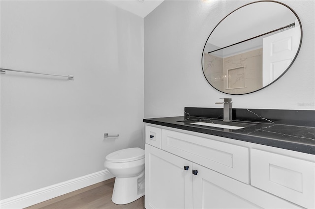 bathroom featuring walk in shower, hardwood / wood-style floors, vanity, and toilet