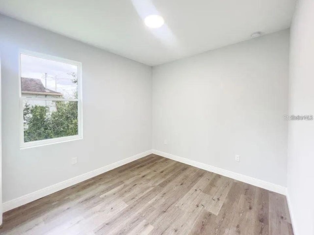 empty room with light hardwood / wood-style flooring