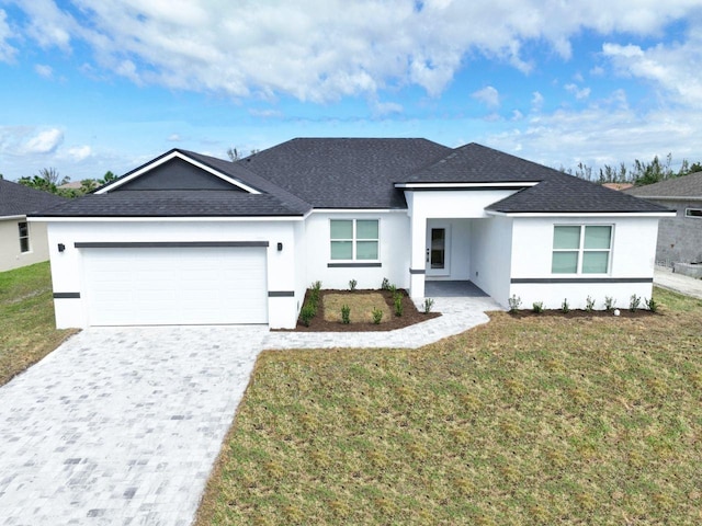 view of front of home with a front yard and a garage