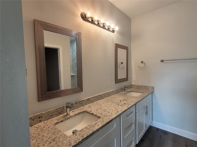 bathroom with vanity and hardwood / wood-style flooring