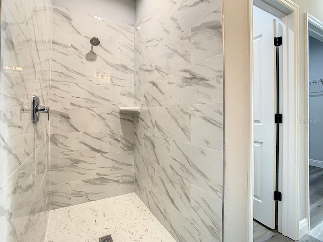 bathroom featuring a tile shower