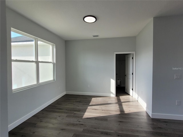 empty room with dark wood-type flooring