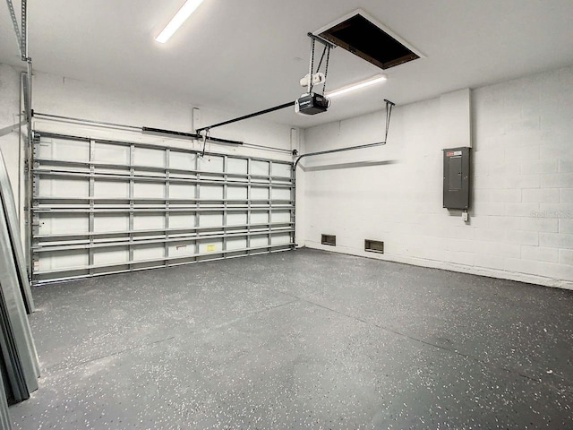 garage with electric panel and a garage door opener