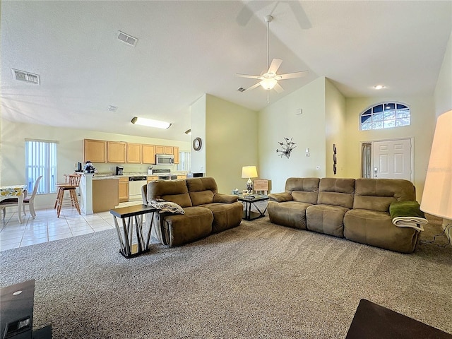 carpeted living room featuring high vaulted ceiling and ceiling fan