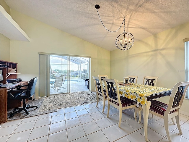 dining room featuring a chandelier, a textured ceiling, lofted ceiling, and light tile patterned flooring