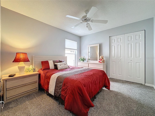 carpeted bedroom with ceiling fan, a textured ceiling, and a closet