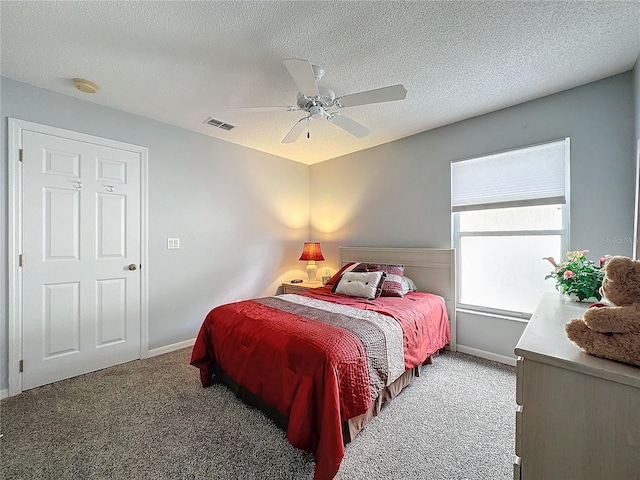 bedroom featuring carpet, ceiling fan, and a textured ceiling