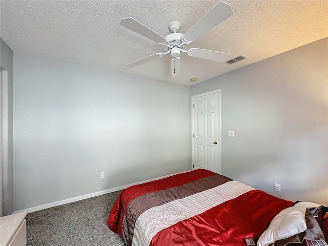 carpeted bedroom with a textured ceiling and ceiling fan