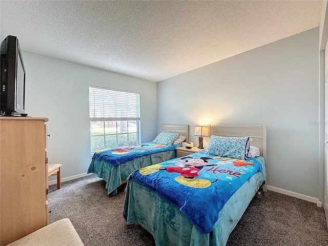 bedroom with dark colored carpet and a textured ceiling