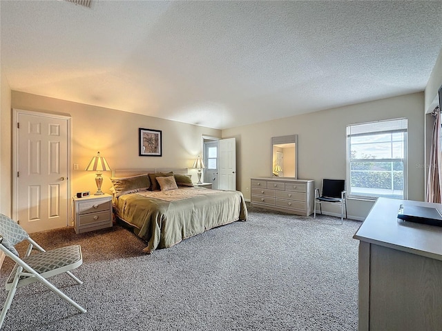 bedroom featuring carpet flooring and a textured ceiling