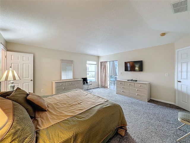 carpeted bedroom featuring a textured ceiling