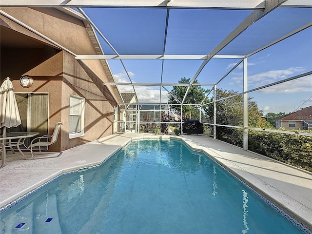 view of pool with a lanai and a patio