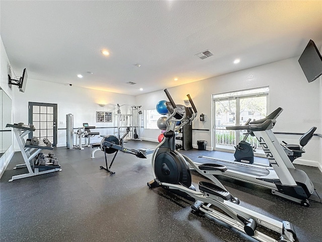 workout area featuring a textured ceiling