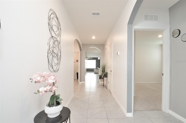 hall with light tile patterned floors