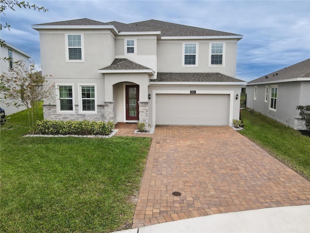 front facade featuring a garage and a front lawn