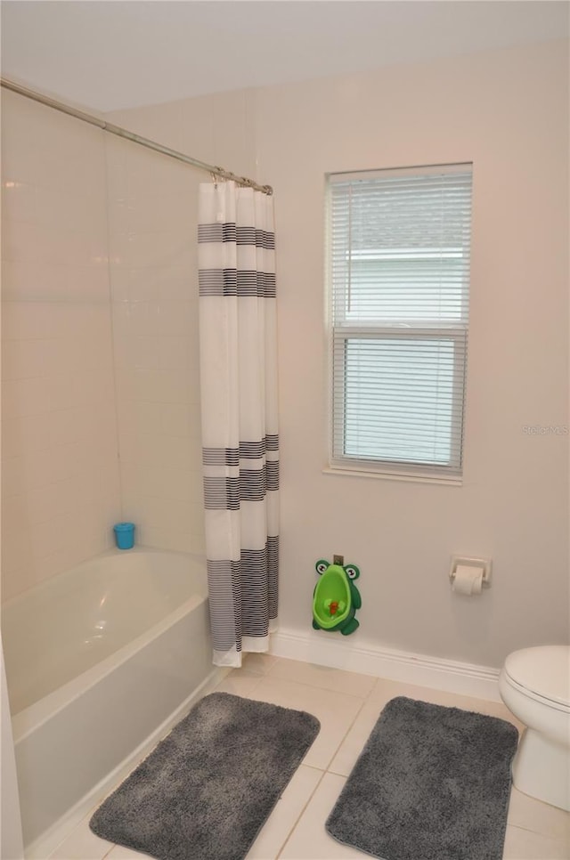 bathroom featuring toilet, tile patterned flooring, and shower / tub combo