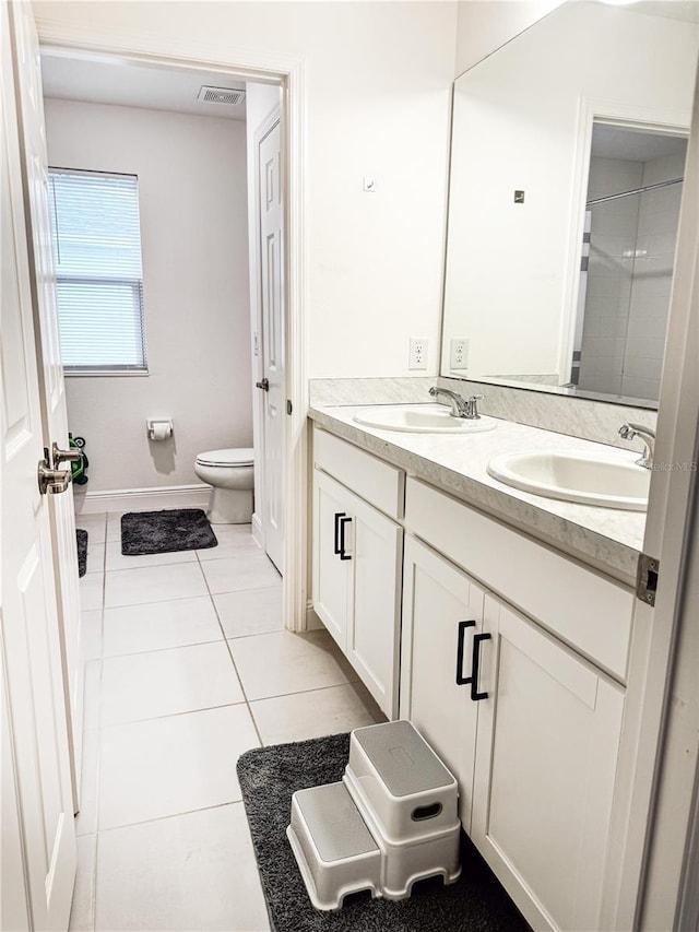 bathroom with vanity, tile patterned floors, and toilet