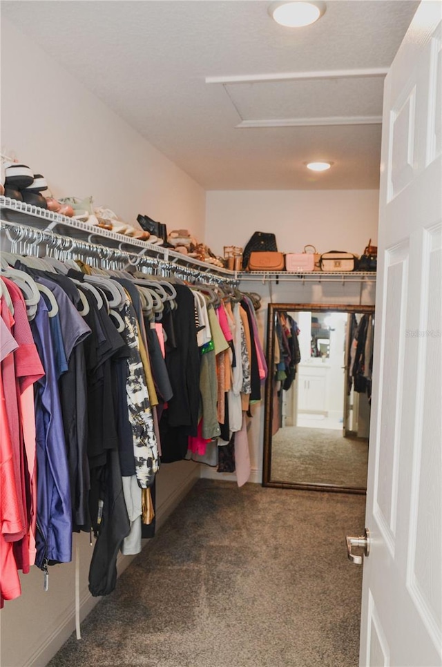 spacious closet featuring dark carpet