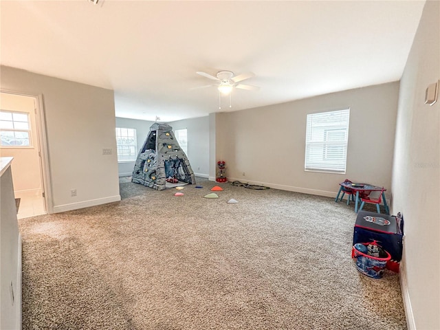 game room with ceiling fan and carpet flooring