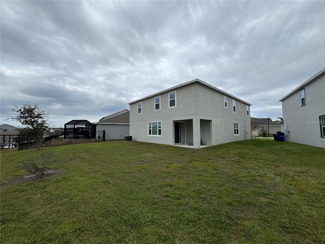 back of house with a lawn