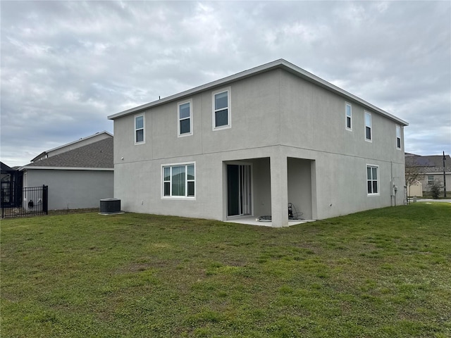 rear view of house featuring a patio area, central AC unit, and a lawn