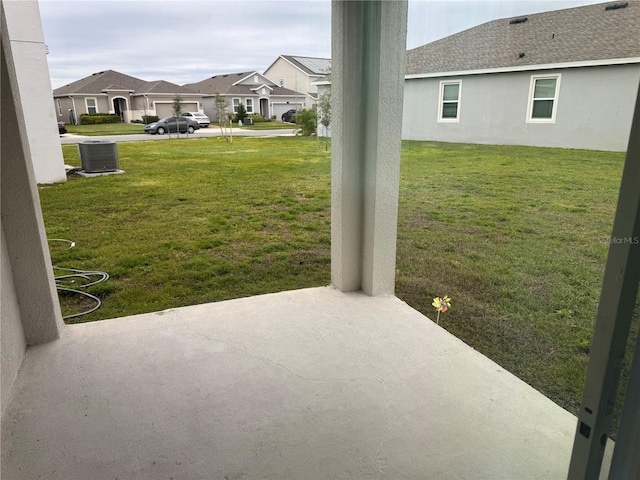 view of yard with central AC and a patio area