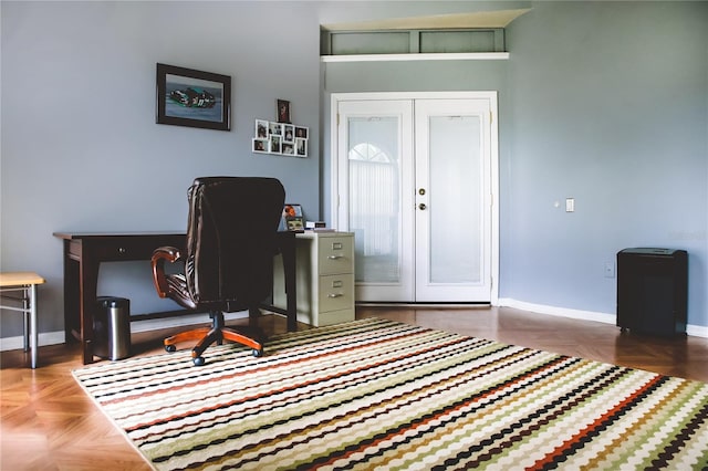 office with dark parquet flooring and french doors