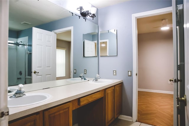 bathroom featuring vanity and a shower with door