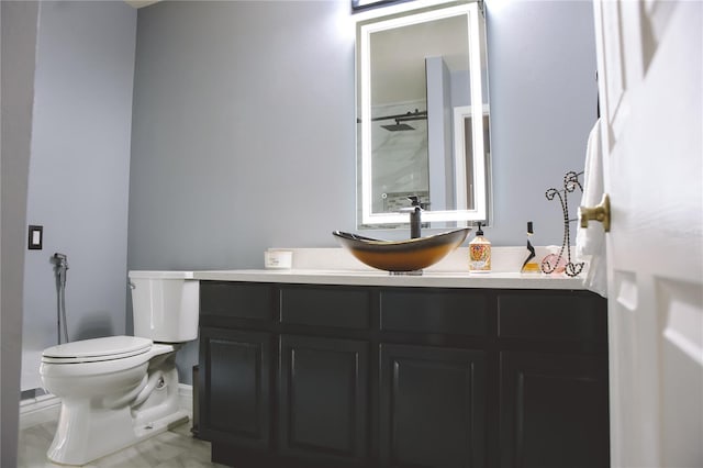 bathroom featuring vanity, toilet, and a shower