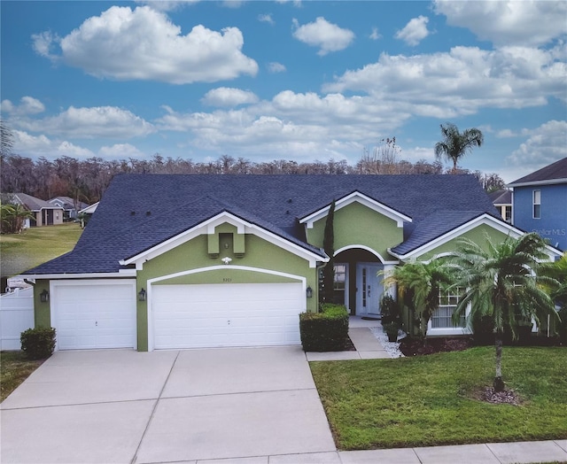 single story home with a garage and a front yard