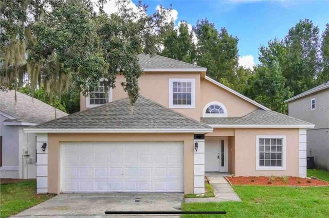 view of front of property featuring a garage and a front lawn